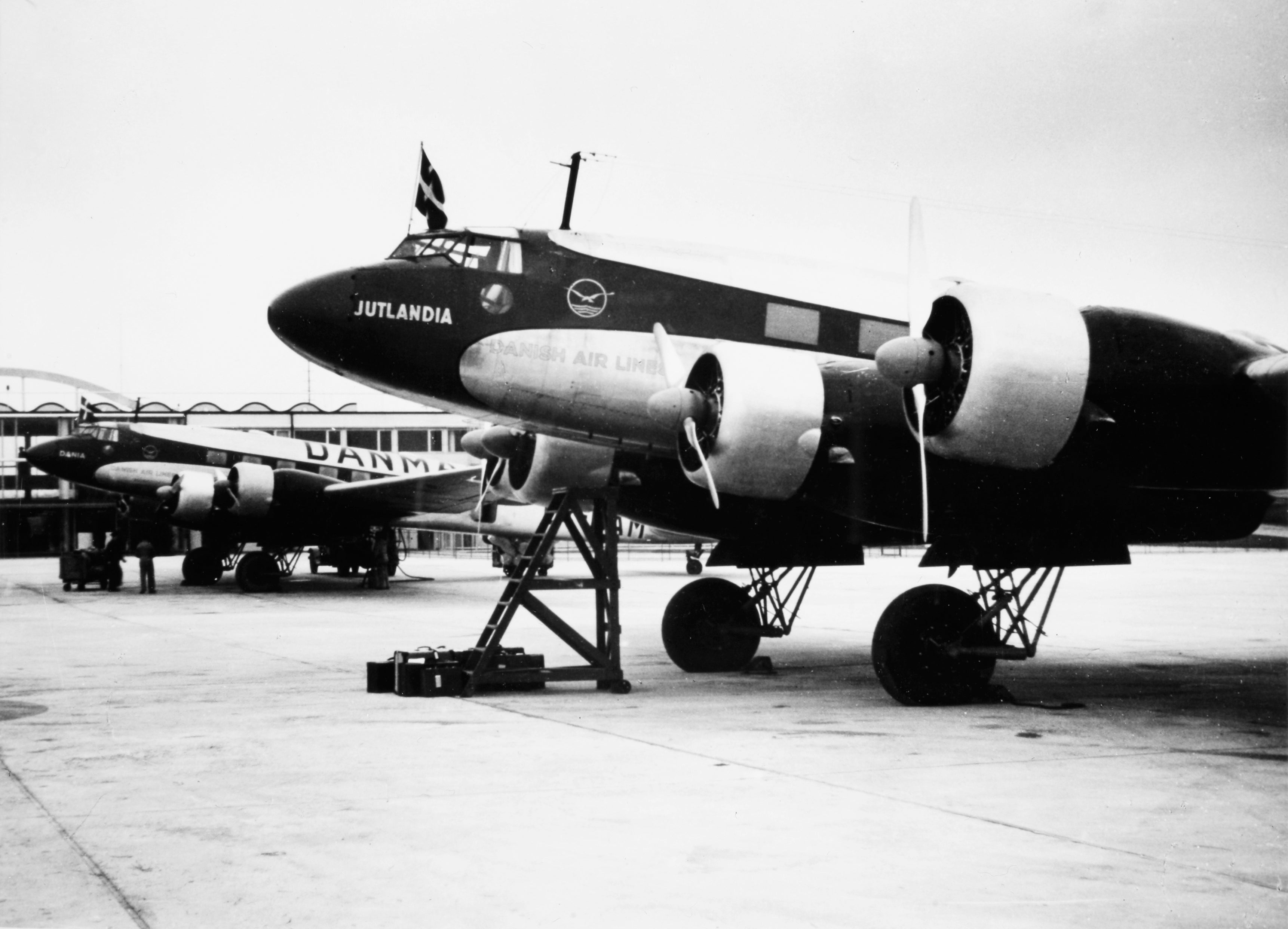 Vintage airplane on a runway with 'Julandia' branding.