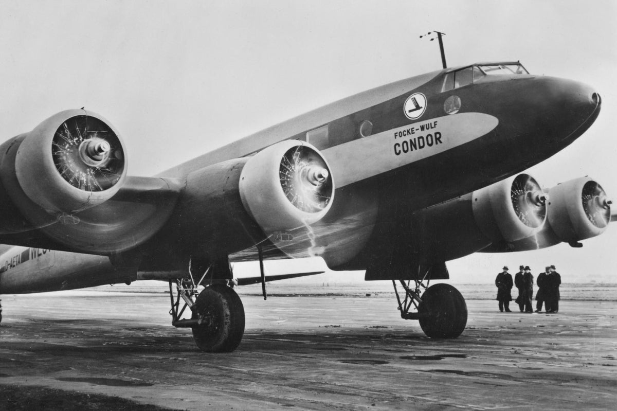 Vintage airplane on a runway with 'Fock-Wulf Condor' branding.